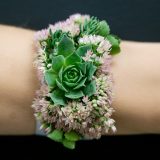a bracelet made out of succulents and flowers