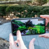 Someone holding a phone in the Perennial Garden.