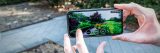 Someone holding a phone in the Perennial Garden.