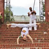 A person performing capoeira.