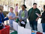 people talking and looking at papers for citizen science weekend