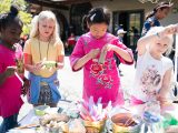 four young children making cork crafts