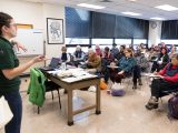 A Bronx Green Up staff person talking to a classroom of people