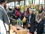 People standing and listening to a staff person discuss plants in the NYBG Shop