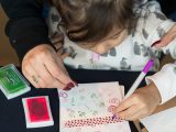 young girl drawing in a plantlove weekend card