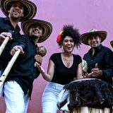 La Cumbiamba eNeYé posing with their instruments.