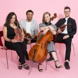 PubliQuartet posing for a picture with their instruments in hand.