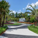 A view of Brazilian Modern's black-and-white curved pathways, plam trees, and flowers.