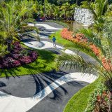 An aerial view of Brazilian Modern, showing black-and-white curved paths, a sculptural water feature, and plants.