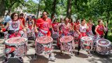 Drummers from Batala NYC walking down Tulip Tree Allée