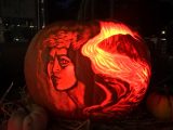 Backlit carved pumpkin of a womans face