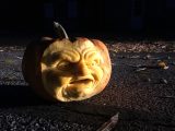 Carved pumpkin on a street in the dark