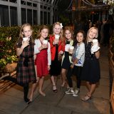 Children holding cups of hot chocolate at the Holiday Train Show Family Benefit