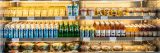 a variety of beverages and salads on display in a cooler.