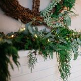 A wreath and garland on a mantle