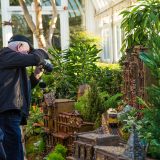 A man taking a photo of the Holiday Train Show