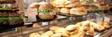 A variety of sandwiches stacked on shelves.