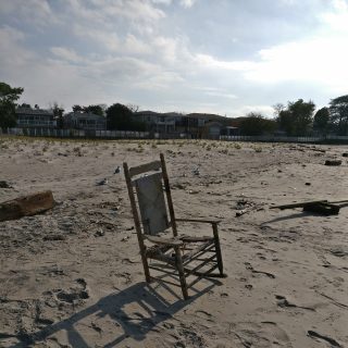 Photo of a chair washed up on a beach