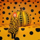 Photo of Yayoi Kusama with pumpkin sculpture