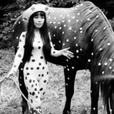 Photo of Yayoi Kusama with a polka-dotted horse