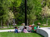 NYBG Staff reading to a group of younger students at the amphitheater