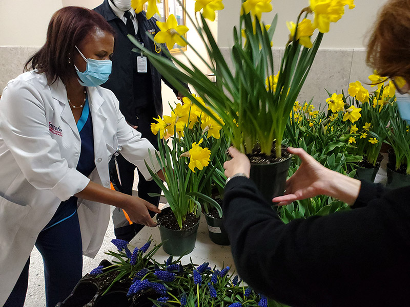 Photo of medical staff receiving flowers