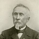 photo portrait of victor lemoine wearing a straight collar shirt with a bow tie and suit jacket