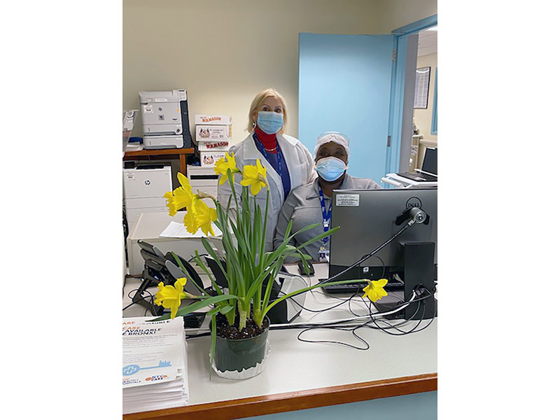 Photo of medical staff receiving flowers