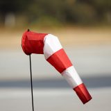Red and white windsock on pole