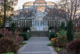 a gray paved path leading to a glasshouse dome