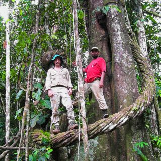 Photo of Douglas Daly and Edilson de Oliveira standing on a vine in the Amazon