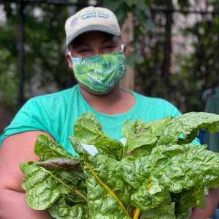 Photo of Kadeesha Williams holding leafy greens