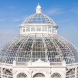 A glass conservatory dome featuring white accents around the glass.