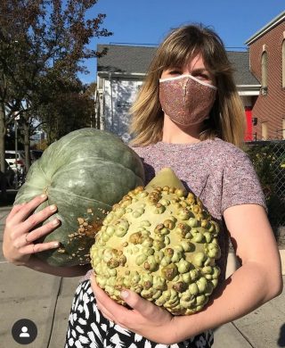 Photo of a volunteer delivering pumpkins