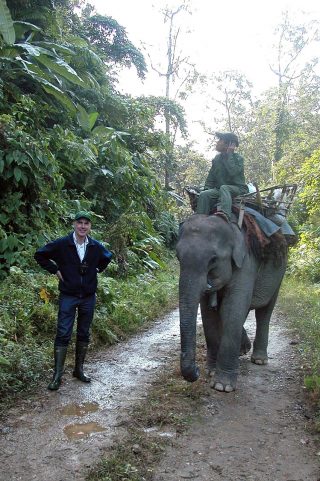 Photo of Andrew Henderson with an elephant