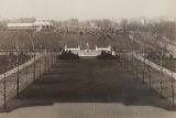 black and white photo looking at two parallel drives lined with bare trees