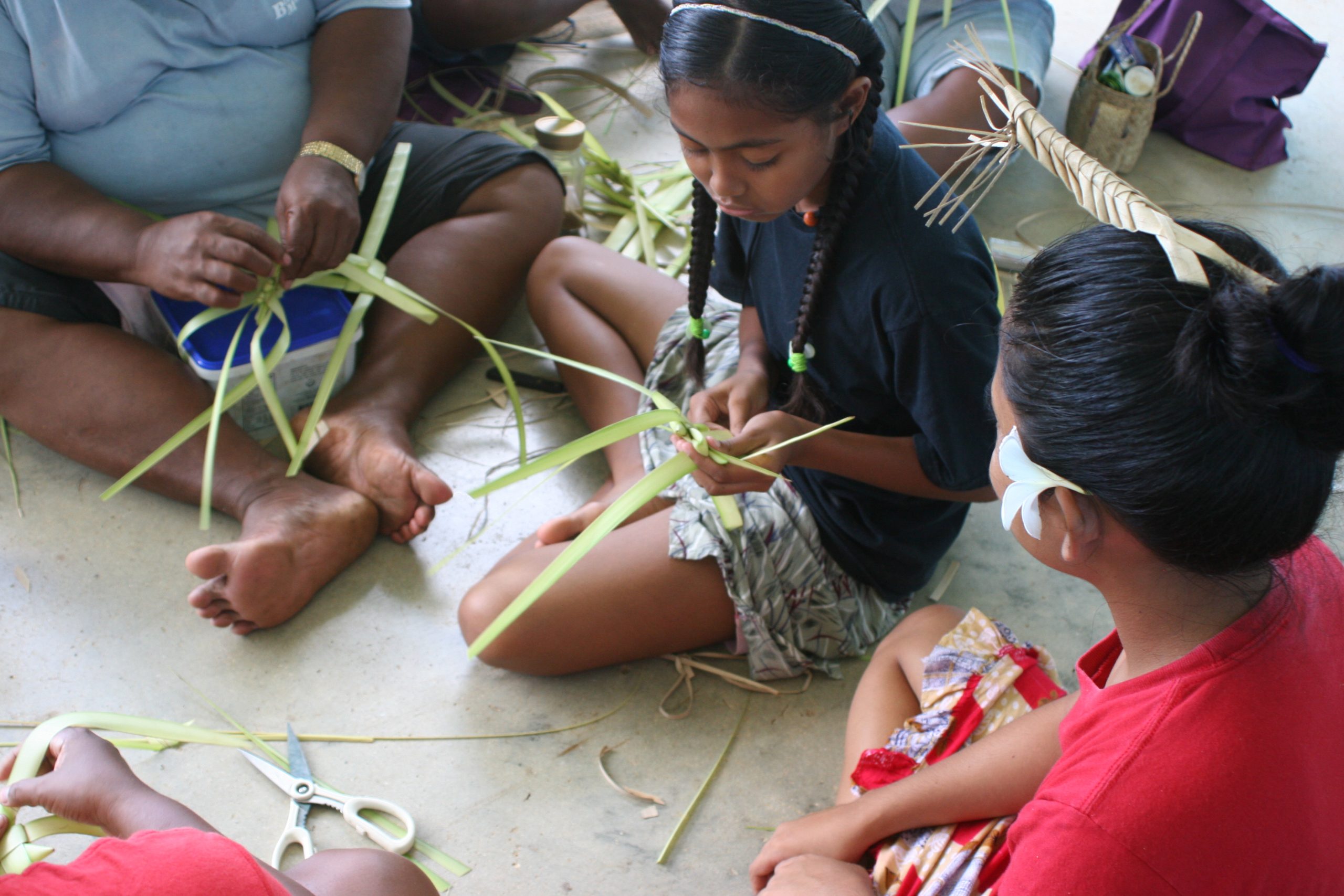 Photo of children learning how to make traditional toys from leaves