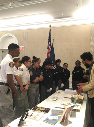 Photo of Rashad Bell speaking with Councilmembers