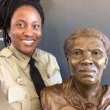 An image of Ranger Angela Crenshaw with a bust of Harriet Tubman