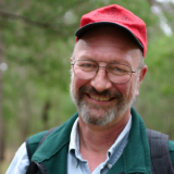 Photo of Roy Halling smiling in a red hat