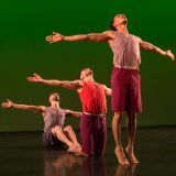 Photo of three men performing interpretive dance
