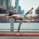 Photo of a dancer performing in front of the New York City skyline