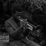 Black and white photo of Giveton Gelin playing trumpet