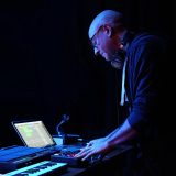 Photo of Darren Solomon in fron to f a DJ set