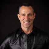 Headshot of designer Jeff Leatham against a black background