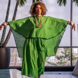 A woman walking the runway in a green dress