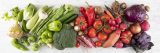 Fresh tomatoes, red peppers, carrots, eggplants, green and red vegetables on white wooden background