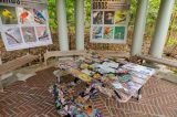 Picnic table painted in black with birds and many artistic artifacts