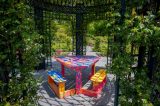 Picnic table painted in pink, blue and yellow