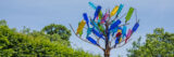 A bottle tree covered in colorful glass